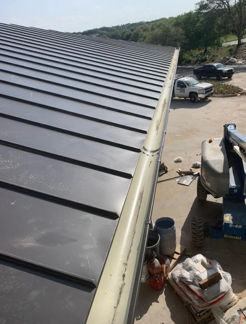 Standing seam panel and gutter detail on a metal roofing jobsite in Rosaryville